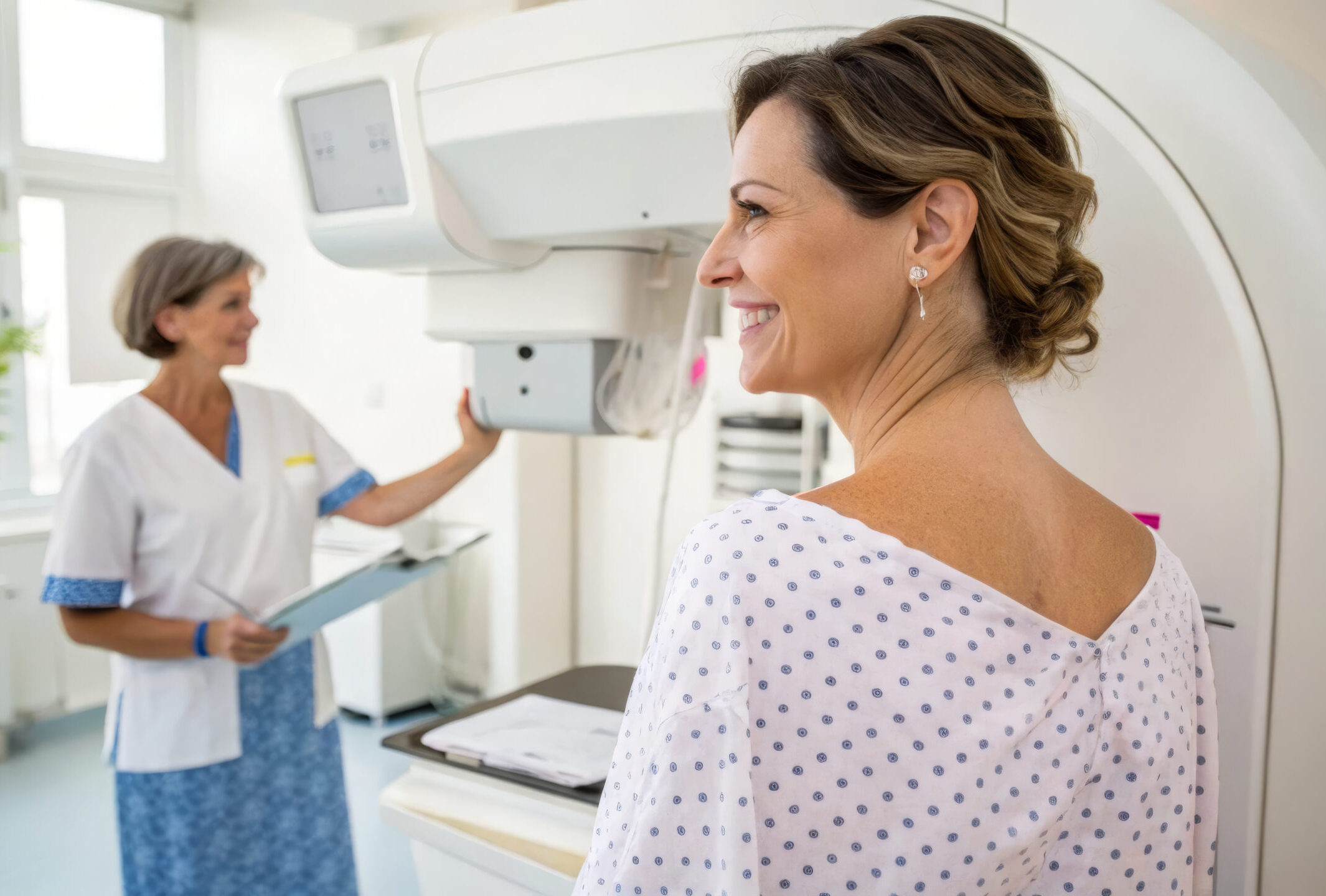 woman smiles during mammogram examination, feeling reassured by medical staff